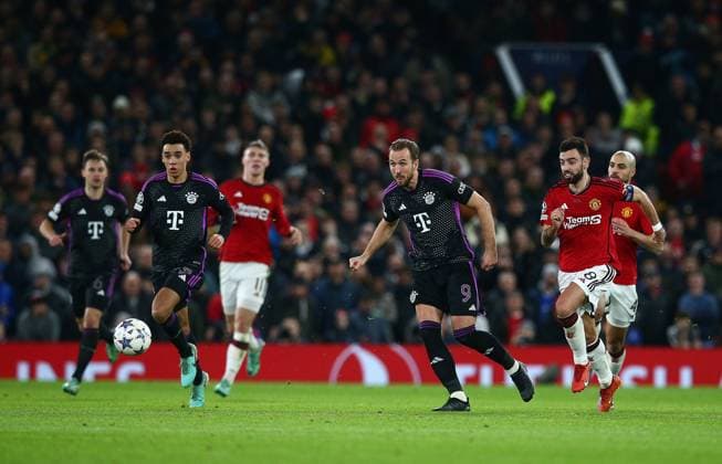 Harry Kane of Bayern Munich passes the ball Manchester United, ManU v Bayern Munich, UEFA Champions League, Group A, Football, Old Trafford, Manchester, UK - 12 Dec 2023 EDITORIAL USE ONLY No use with unauthorised audio, video, data, fixture lists, club league logos or live services. Online in-match use limited to 120 images, no video emulation. No use in betting, games or single club league player publications.  Copyright: xMattxWest Shutterstockx 14254194az