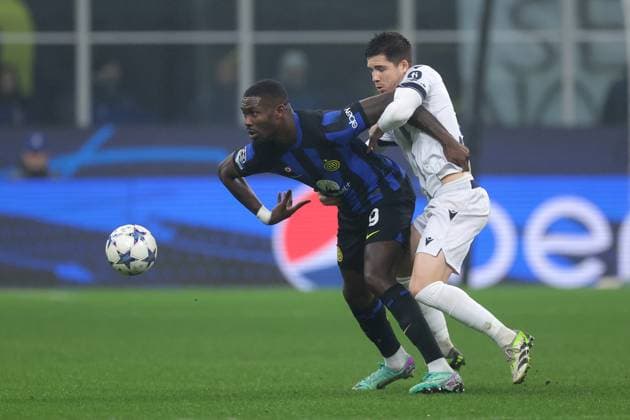 Milan, Italy, 12th December 2023. Igor Zubeldia of Real Sociedad tussles with Marcus Thuram of FC Internazionale during the UEFA Champions League match at Giuseppe Meazza, Milan. Picture credit should read: Jonathan Moscrop Sportimage EDITORIAL USE ONLY. No use with unauthorised audio, video, data, fixture lists, club league logos or live services. Online in-match use limited to 120 images, no video emulation. No use in betting, games or single club league player publications. SPI-2786-0009