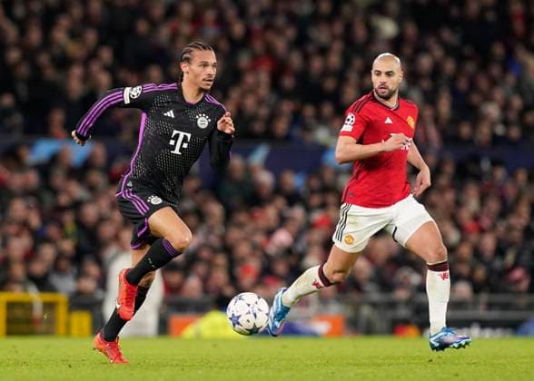 Manchester, England, 12th December 2023. Leroy SanÃ of Bayern Munich and Sofyan Amrabat of Manchester United, ManU during the UEFA Champions League match at Old Trafford, Manchester. Picture credit should read: Andrew Yates Sportimage EDITORIAL USE ONLY. No use with unauthorised audio, video, data, fixture lists, club league logos or live services. Online in-match use limited to 120 images, no video emulation. No use in betting, games or single club league player publications. SPI-2800-0031