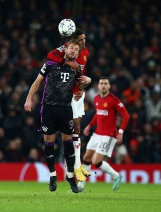 RaphaÃ«l Varane of Manchester United, ManU challenges Harry Kane of Bayern Munich in a header Manchester United v Bayern Munich, UEFA Champions League, Group A, Football, Old Trafford, Manchester, UK - 12 Dec 2023 EDITORIAL USE ONLY No use with unauthorised audio, video, data, fixture lists, club league logos or live services. Online in-match use limited to 120 images, no video emulation. No use in betting, games or single club league player publications.  Copyright: xMattxWest Shutterstockx 14254194bf