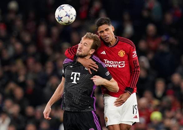 Manchester, England, 12th December 2023. Raphael Varane of Manchester United, ManU gets to grips with Harry Kane of Bayern Munich during the UEFA Champions League match at Old Trafford, Manchester. Picture credit should read: Andrew Yates Sportimage EDITORIAL USE ONLY. No use with unauthorised audio, video, data, fixture lists, club league logos or live services. Online in-match use limited to 120 images, no video emulation. No use in betting, games or single club league player publications. SPI-2800-0035