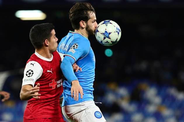 Victor Gomez of SC Braga and Khvicha Kvaratskhelia of SSC Napoli compete for the ball during the Champions League Group C football match between SSC Napoli and SC Braga at Diego Armando Maradona stadium in Naples (Italy), December 12th, 2023. cesarexpurini