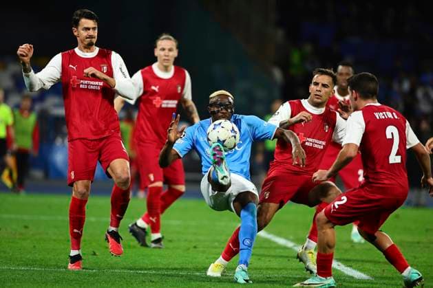 Victor Osimhen of SSC Napoli in action, challenged by four opponents, during the Champions League Group C football match between SSC Napoli and SC Braga at Diego Armando Maradona stadium in Naples (Italy), December 12th, 2023. cesarexpurini