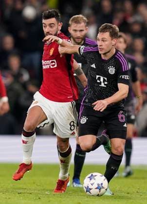 Manchester, England, 12th December 2023. Bruno Fernandes of Manchester United, ManU (L) challenges Joshua Kimmich of Bayern Munich during the UEFA Champions League match at Old Trafford, Manchester. Picture credit should read: Andrew Yates Sportimage EDITORIAL USE ONLY. No use with unauthorised audio, video, data, fixture lists, club league logos or live services. Online in-match use limited to 120 images, no video emulation. No use in betting, games or single club league player publications. SPI-2800-0096