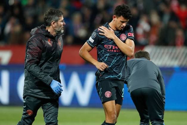 Matheus Nunes of Manchester City holds his shoulder after picking up an injury during the game Crvena zvezda v Manchester City, UEFA Champions League, Group G, Football, Rajko Mitic Stadium, Belgrade, Serbia - 13 Dec 2023 EDITORIAL USE ONLY No use with unauthorised audio, video, data, fixture lists, club league logos or live services. Online in-match use limited to 120 images, no video emulation. No use in betting, games or single club league player publications. Copyright: xNikolaxKrstic Shutterstockx 14254230bs