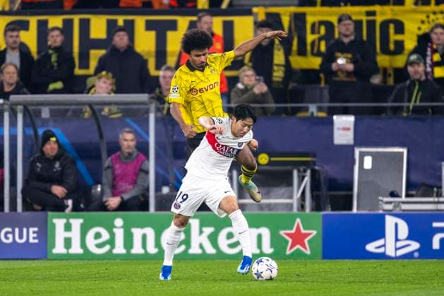 Soccer Champions League Matchday 6 Borussia Dortmund Paris St Germain on 13 12 2023 at Signal Iduna Park Dortmunds Karim Adeyemi l and PSGs Kang in Lee fight for the ball IMPORTANT NOTE In accordance with UEFA regulations, it is prohibited to use or have used photographs taken in the stadium and or of the match in the form of sequential images and or video-like photo series Copyright: xKirchner DavidxInderliedx