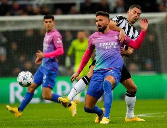 13th December 2023; St James Park, Newcastle, England; UEFA Champions League Football, Newcastle United versus AC Milan; Olivier Giroud of AC Milan holds off Fabian Schar of Newcastle United  ActionPlus12585480 GrahamxWilson