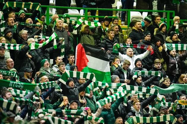Celtic fans hold up green and white scarves and a Palestine flag. Celtic v Feyenoord, UEFA Champions League, Group E, Football, Celtic Park, Glasgow, UK - 13 Dec 2023 EDITORIAL USE ONLY No use with unauthorised audio, video, data, fixture lists, club league logos or live services. Online in-match use limited to 120 images, no video emulation. No use in betting, games or single club league player publications.  Copyright: xStuartxWallace Shutterstockx 14254242aj