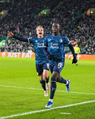 Yankuba Minteh of Feyenoord celebrates scoring to tie the game 1-1, with Thomas van den Belt of Feyenoord, left. Celtic v Feyenoord, UEFA Champions League, Group E, Football, Celtic Park, Glasgow, UK - 13 Dec 2023 EDITORIAL USE ONLY No use with unauthorised audio, video, data, fixture lists, club league logos or live services. Online in-match use limited to 120 images, no video emulation. No use in betting, games or single club league player publications.  Copyright: xStuartxWallace Shutterstockx 14254242as