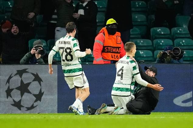 A Celtic fans runs on to the pitch to celebrate with Gustaf Lagerbielke of Celtic while Lagerbielke celebrates scoring to give Celtic a 2-1 lead. Celtic v Feyenoord, UEFA Champions League, Group E, Football, Celtic Park, Glasgow, UK - 13 Dec 2023 EDITORIAL USE ONLY No use with unauthorised audio, video, data, fixture lists, club league logos or live services. Online in-match use limited to 120 images, no video emulation. No use in betting, games or single club league player publications.  Copyright: xStuartxWallace Shutterstockx 14254242bc