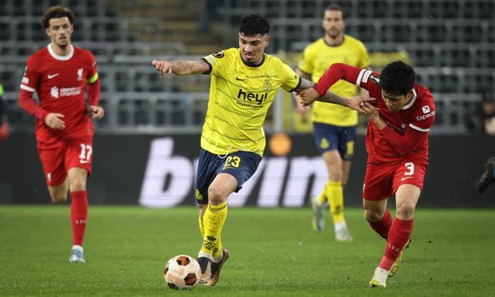 Union s Cameron Puertas Castro and Liverpool s Wataru Endo fight for the ball during a game between Belgian soccer team Royale Union Saint Gilloise and English club Liverpool FC, on Thursday 14 December 2023 in Brussels, on the sixth and last day of the group phase of the UEFA Europa League competition, in group E. VIRGINIExLEFOUR  x82339421x