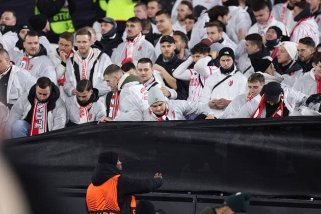 London, England, 14th December 2023. SC Freiburg fans attempt to get closer to the action by climbing under the segregation material during the UEFA Europa League match at the London Stadium, London. Picture credit should read: David Klein Sportimage EDITORIAL USE ONLY. No use with unauthorised audio, video, data, fixture lists, club league logos or live services. Online in-match use limited to 120 images, no video emulation. No use in betting, games or single club league player publications. SPI-2801-0006