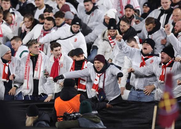 London, England, 14th December 2023. SC Freiburg fans attempt to get closer to the action by climbing under the segregation material during the UEFA Europa League match at the London Stadium, London. Picture credit should read: David Klein Sportimage EDITORIAL USE ONLY. No use with unauthorised audio, video, data, fixture lists, club league logos or live services. Online in-match use limited to 120 images, no video emulation. No use in betting, games or single club league player publications. SPI-2801-0008