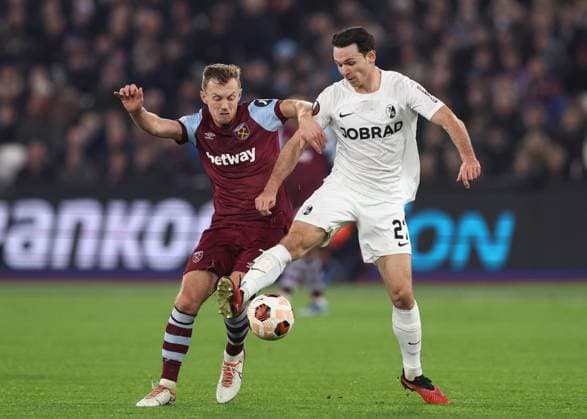London, England, 14th December 2023. James Ward-Prowse of West Ham United challenges Nicolas Hofler of SC Freiburg during the UEFA Europa League match at the London Stadium, London. Picture credit should read: David Klein Sportimage EDITORIAL USE ONLY. No use with unauthorised audio, video, data, fixture lists, club league logos or live services. Online in-match use limited to 120 images, no video emulation. No use in betting, games or single club league player publications. SPI-2801-0022