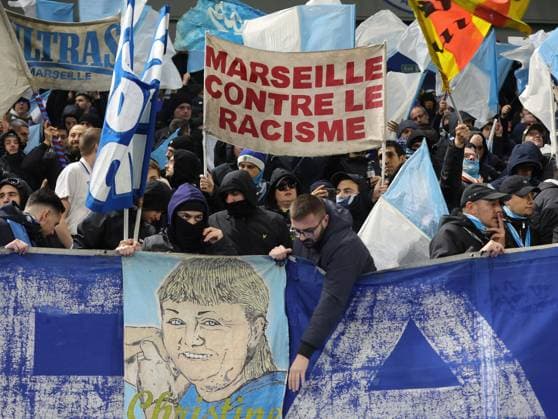 Brighton and Hove, England, 14th December 2023. Marseille fans wave signs and flags during the UEFA Europa League match at the AMEX Stadium, Brighton and Hove. Picture credit should read: Paul Terry Sportimage EDITORIAL USE ONLY. No use with unauthorised audio, video, data, fixture lists, club league logos or live services. Online in-match use limited to 120 images, no video emulation. No use in betting, games or single club league player publications. SPI-2802-0009