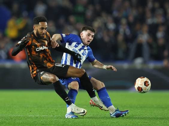 Brighton and Hove, England, 14th December 2023. Pierre-Emerick Aubameyang of Olympique de Marseille and Billy Gilmour of Brighton and Hove Albion challenge for the ball during the UEFA Europa League match at the AMEX Stadium, Brighton and Hove. Picture credit should read: Paul Terry Sportimage EDITORIAL USE ONLY. No use with unauthorised audio, video, data, fixture lists, club league logos or live services. Online in-match use limited to 120 images, no video emulation. No use in betting, games or single club league player publications. SPI-2802-0011