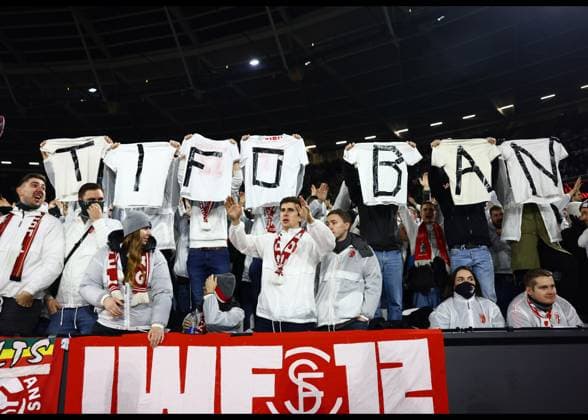 London, England, 14th December 2023. SC Freiburg fans hold up t-shirts saying Tifo Ban during the UEFA Europa League match at the London Stadium, London. Picture credit should read: David Klein Sportimage EDITORIAL USE ONLY. No use with unauthorised audio, video, data, fixture lists, club league logos or live services. Online in-match use limited to 120 images, no video emulation. No use in betting, games or single club league player publications. SPI-2801-0037