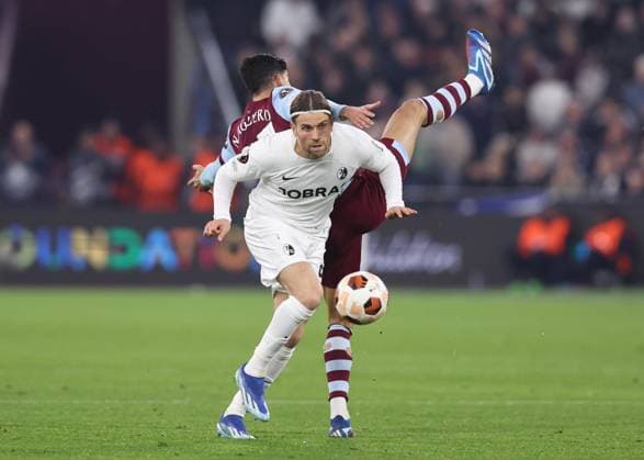 London, England, 14th December 2023. Manuel Guide of SC Freiburg tussles with Nayef Aguerd of West Ham United during the UEFA Europa League match at the London Stadium, London. Picture credit should read: David Klein Sportimage EDITORIAL USE ONLY. No use with unauthorised audio, video, data, fixture lists, club league logos or live services. Online in-match use limited to 120 images, no video emulation. No use in betting, games or single club league player publications. SPI-2801-0041