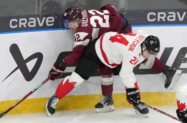 December 27, 2023, GOTHENBURG, SWEDEN: Canada s Denton Mateychuk (24) checks Latvia s Sandis Vilmanis (22) into the boards during first period hockey action at the IIHF World Junior Hockey Championship in Gothenburg, Sweden on Wednesday, Dec. 27, 2023. Canada News - December 27, 2023  - ZUMAc35_ 20231227_zaf_c35_004 Copyright: xChristinnexMuschix