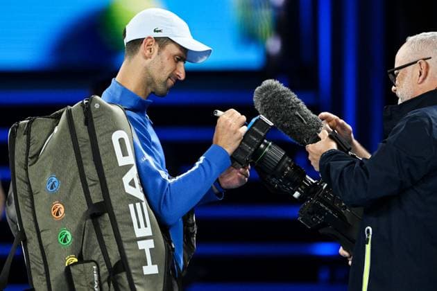 Novak Djokovic (SRB) signs a camera lens as he celebrates winning his third round match Australian Open, Day Six, Tennis, Melbourne Park, Melbourne, Australia - 19 Jan 2024  Copyright: xJamesxGourley Shutterstockx 14306114bq