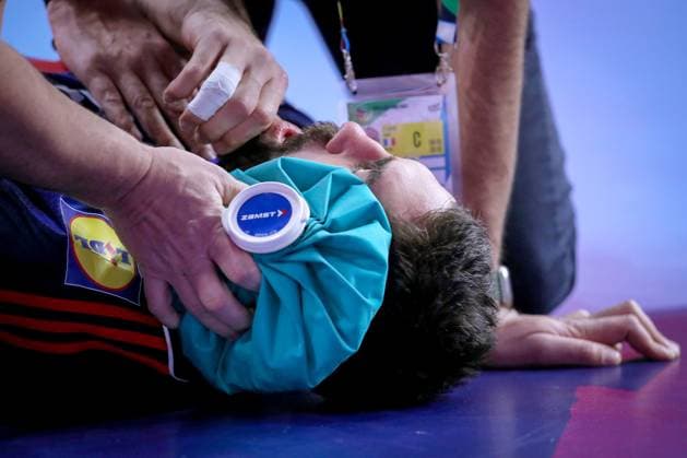 20 01 2024, EHF EURO 2024, European Mens Handball Championship, Lanxess Arena in Cologne, France Iceland Nikola Karabatic France lies on the ground in pain and is treated with an ice pack North Rhine-Westphalia Germany