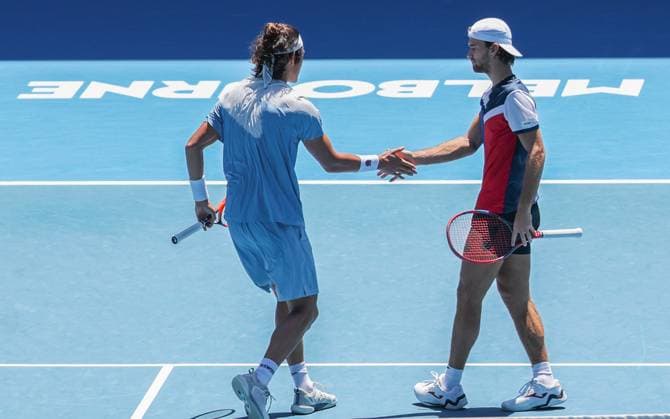 (240123) -- MELBOURNE, Jan. 23, 2024 -- Zhang Zhizhen (L) Tomas Machac react during the men s doubles quarterfinal between Zhang Zhizhen (China) Tomas Machac (the Czech Republic) and Ariel Behar (Uruguay) Adam Pavlasek (the Czech Republic) at the Australian Open tennis tournament in Melbourne, Australia, Jan. 23, 2024. (Photo by Xinhua) (SP)AUSTRALIA-MELBOURNE-TENNIS-AUSTRALIAN OPEN HuxJingchen 