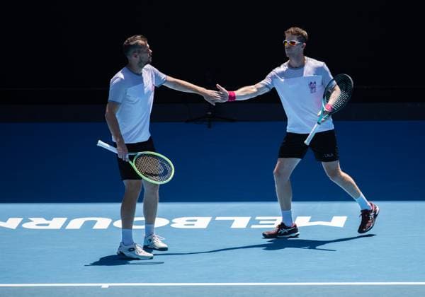 (240123) -- MELBOURNE, Jan. 23, 2024 -- Ariel Behar (R) Adam Pavlasek react during the men s doubles quarterfinal between Zhang Zhizhen (China) Tomas Machac (the Czech Republic) and Ariel Behar (Uruguay) Adam Pavlasek (the Czech Republic) at the Australian Open tennis tournament in Melbourne, Australia, Jan. 23, 2024. (Photo by Xinhua) (SP)AUSTRALIA-MELBOURNE-TENNIS-AUSTRALIAN OPEN HuxJingchen 