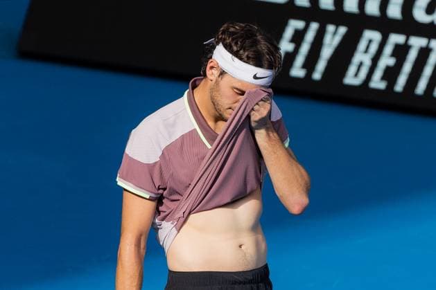 (240123) -- MELBOURNE, Jan. 23, 2024 -- Taylor Fritz reacts during the men s singles quarterfinal match between Novak Djokovic of Serbia and Taylor Fritz of the United States at Australian Open tennis tournament in Melbourne, Australia, Jan. 23, 2024. (Photo by Xinhua) (SP)AUSTRALIA-MELBOURNE-TENNIS-AUSTRALIAN OPEN ChuxChen 