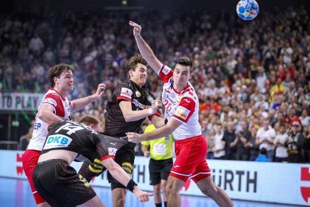24 01 2024, EHF EURO 2024, European Mens Handball Championship, Lanxess Arena in Cologne, Germany Croatia Justus Fischer Germany and Julian Köster Germany are tied up by Veron Nacinovic Croatia and Mateo Maras Croatia North Rhine-Westphalia Germany