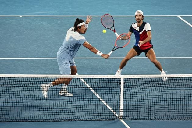 Zhang Zhizhen bright , CHN, and Tomas Machac red, blue , CZE, during mens doubles of 2024 Australian Open in Melbourne, 25 01 2023
