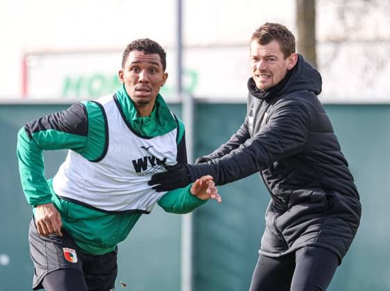 Lars Knudsen Co Trainer FC Augsburg in a duel against Felix Uduokhai FC Augsburg 19 in front of a cross FC Augsburg, training,