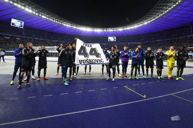 03 02 2024, xtgx, Soccer 2 Bundesliga, Hertha BSC Berlin Hamburger SV emspor, v l Hamburg jubilation over the victory, jubilation after the end of the match , they hold a banner saying Free 44 Vuskovic DFL DFB REGULATIONS PROHIBIT ANY USE OF PHOTOGRAPHS as IMAGE SEQUENCES and or QUASI VIDEO Berlin