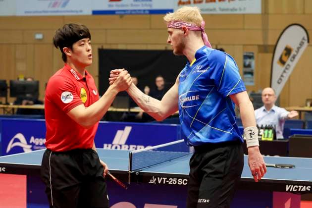 Dang Qiu Borussia Duesseldorf and Romain Ruiz TTC Schwalbe Bergneustadt shake hands, 1 German mens table tennis league, TTC Schwalbe Bergneustadt vs Borussia Düsseldorf, Burstenhalle, 04 02 2024, Bergneustadt, Germany