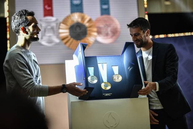 Paris 2024 Olympic Medals Feature Iron From The Eiffel Tower President of Paris 2024, Tony Estanguet (R) and retired French biathlete and sous-lieutenant Martin Fourcade unveil the Paris 2024 Olympic and Paralympic Games medals at the Paris 2024 headquarters in Saint-Denis on February 8, 2024. The medals at this year?s Olympics in Paris were not only inspired by the Eiffel Tower they each contain an original piece of the 19th-century landmark. Unveiling the designs Thursday, Games organizers said that ironwork removed from the structure during earlier renovations had been repurposed to create the medals? hexagonal centerpiece. The move, they added, would give successful athletes veritable pieces of the history of Paris to take home with them. Photo by Firas Abdullah ABACAPRESS.COM Paris Ile-de-France France  Copyright: xAbdullahxFiras ABACAx