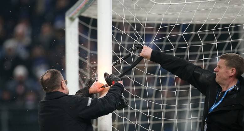 09 02 2024, Soccer 2 Bundesliga 2023 2024, 21 Matchday, Hamburger SV Hannover 96 , in Volksparkstadion Hamburg Fan protest against the DFLs investor plans, HSV supporters attach locks to the goal during the half-time break, these have to be removed with an angle grinder, this delays the restart DFL and DFB regulations prohibit any use of photographs as image sequences and or quasi video