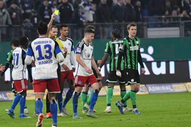 GER 2 FBL,, Hamburger SV vs Hannover 96 09 02 2024, Volksparkstadion, Hamburg, GER 2 FBL, Hamburger SV vs Hannover 96 in the picture the fans of Hannover protest against the DFB and the match is interrupted Referee Soeren Storks shows Laszlo Benes Hamburg 08 the yellow card nordphotoxGmbH xWitke nph00002