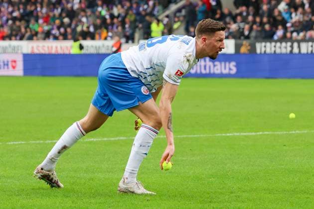 Janik Bachmann Hansa Rostock picks up a tennis ball thrown by the fans, 2 Bundesliga, VfL Osnabrueck vs Hansa Rostock, Bremer Bruecke, 11 02 2024, Osnabrueck, Germany