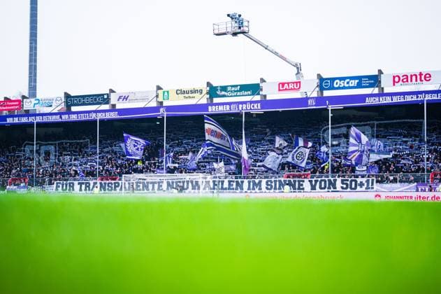 11 02 2024 Soccer, 2023 2024, 2 Bundesliga, 21 Matchday, VfL Osnabrück FC Hansa Rostock Fans Osnabrück with banner For transparent new elections in the sense of 50 1 against the investors of the DFL, Deutsche Fußball Liga DFL REGULATIONS PROHIBIT ANY USE OF PHOTOGRAPHS AS IMAGE SEQUENCES AND OR QUASI VIDEO