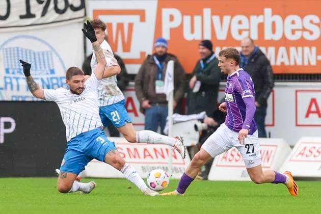 Konstantinos Stafylidis Hansa Rostock and Michael Cuisance VfL Osnabrueck fight for the ball, 2 Bundesliga, VfL Osnabrueck vs Hansa Rostock, Bremer Bruecke, 11 02 2024, Osnabrueck, Germany