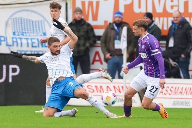 Konstantinos Stafylidis Hansa Rostock and Michael Cuisance VfL Osnabrueck fight for the ball, 2 Bundesliga, VfL Osnabrueck vs Hansa Rostock, Bremer Bruecke, 11 02 2024, Osnabrueck, Germany