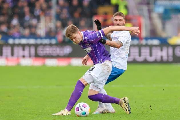 Lukas Kunze VfL Osnabrueck and Konstantinos Stafylidis Hansa Rostock fight for the ball, 2 Bundesliga, VfL Osnabrueck vs Hansa Rostock, Bremer Bruecke, 11 02 2024, Osnabrueck, Germany
