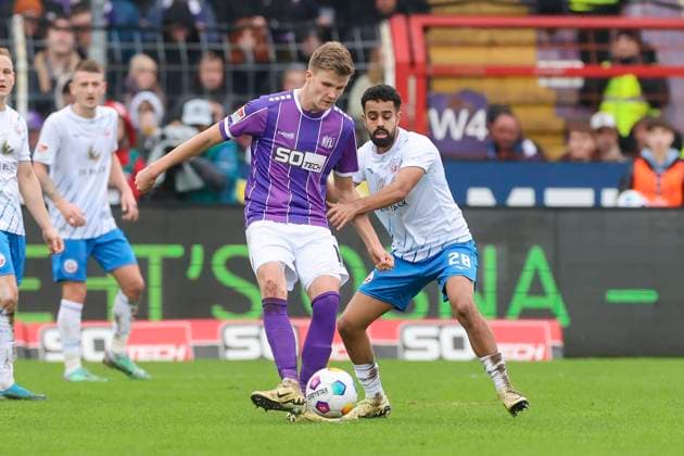 Lukas Kunze VfL Osnabrueck and Sarpreet Singh Hansa Rostock fight for the ball, 2 Bundesliga, VfL Osnabrueck vs Hansa Rostock, Bremer Bruecke, 11 02 2024, Osnabrueck, Germany