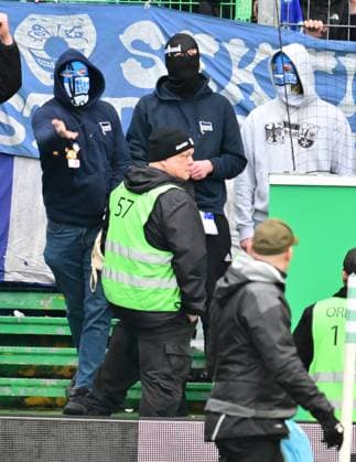 21 02 2024 Soccer Season 2023 2024 2 Soccer Bundesliga 21 Matchday SpVgg Greuther Fürth Kleeblatt Hertha BSC Berlin Sportfoto Zink xmexzix DFL regulations prohibit any use of photographs as image sequences and or quasi video only for editorial use masked Hertha fans have fun with stewards inside the stadium protest throw objects on the pitch stewards only watch