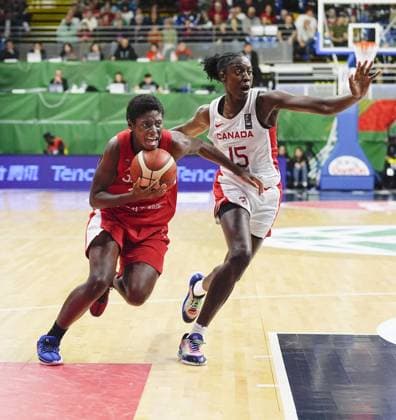 Basketball: Olympic women s qualifier Japan s Evelyn Mawuli (L) goes on the attack as Canada s Laeticia Amihere plays defense in the first quarter of an Olympic women s basketball qualifier on Feb. 11, 2024, in Sopron, Hungary.  A14AA0002454588P