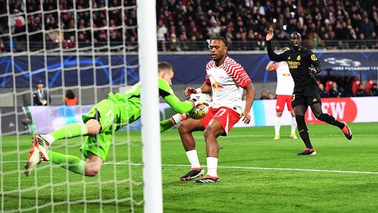 Soccer UEFA Champions League, season 2023 2024, round of 16, first leg, RB Leipzig vs Real Madrid 13 02 2024 Andriy Lunin goalkeeper Real Madrid, back number 13 li saves a ball from Lois Openda center forward RB Leipzig, back number 17, 17 at the match RB Leipzig vs Real Madrid 13 02 2024 Leipzig Saxony Germany Red Bull Arena