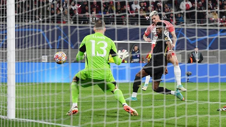 Soccer UEFA Champions League, Season 2023 2024, Round of 16, First leg, RB Leipzig vs Real Madrid 13 02 2024 Goal kick Benjamin Sesko Midfielder RB Leipzig, back number 30, 30 center vs Andriy Lunin Goalkeeper Real Madrid, back number 13 left and Aurélien Tchouaméni Defensive midfield Real Madrid, back number 18 right at the match RB Leipzig vs Real Madrid 13 02 2024 Leipzig Saxony Germany Red Bull Arena