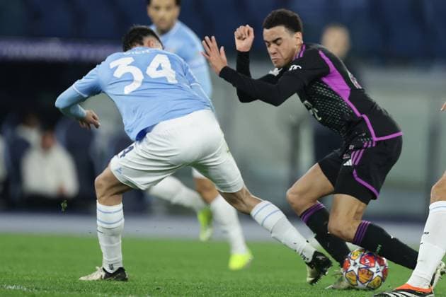 UEFA Champions League SS Lazio vs Bayern Munich Lazio™s Spanish defender Mario Gila challenges for the ball with Bayern Munich s German midfielder Jamal Musiala during the UEFA Champions League Round of 16, first-leg football match between SS Lazio vs Bayern Munich in Rome, on February 14, 2024. ABPH7242 Copyright: xAntonioxBalascox