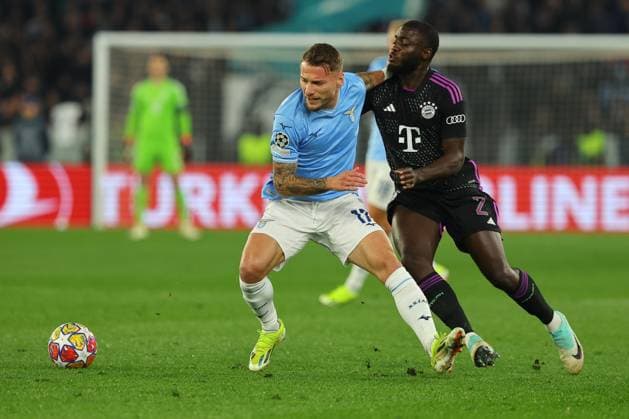 UEFA CHAMPIONS LEAGUE 2023-2024 - Round 16 - SS Lazio vs Bayern Munchen, Olympic Stadium in Rome Rome, Italy 14.2.2024: Ciro Immobile of Lazio fight for the ball with Dayot Upamecano of Bayern Munchen in action during the Uefa Champions League 2023-2024, round of 16 football match SS Lazio vs FC Bayern Mucnhen at Olympic Stadium in Rome. Rome Olympic italy italy Copyright: xmarcoxiacobucci