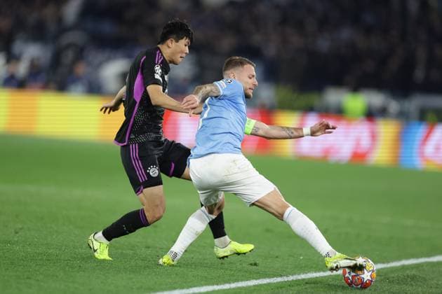 UEFA Champions League SS Lazio vs Bayern Munich Bayern Munich s Korean defender Kim Min-Jae challenges for the ball with Lazio™s Italian forward Ciro Immobile during the UEFA Champions League Round of 16, first-leg football match between SS Lazio vs Bayern Munich in Rome, on February 14, 2024. ABPH7477 Copyright: xAntonioxBalascox