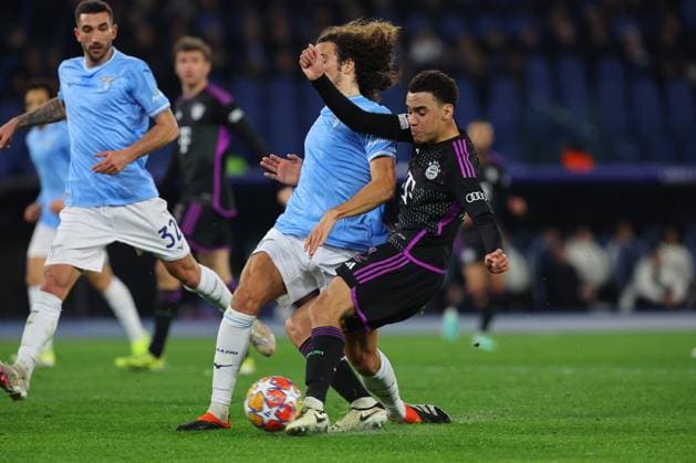 UEFA CHAMPIONS LEAGUE 2023-2024 - Round 16 - SS Lazio vs Bayern Munchen, Olympic Stadium in Rome Rome, Italy 14.2.2024: Guendouzi of Lazio , Jamal Musiala of Bayern Munchen in action during the Uefa Champions League 2023-2024, round of 16 football match SS Lazio vs FC Bayern Mucnhen at Olympic Stadium in Rome. Rome Olympic italy italy Copyright: xmarcoxiacobucci